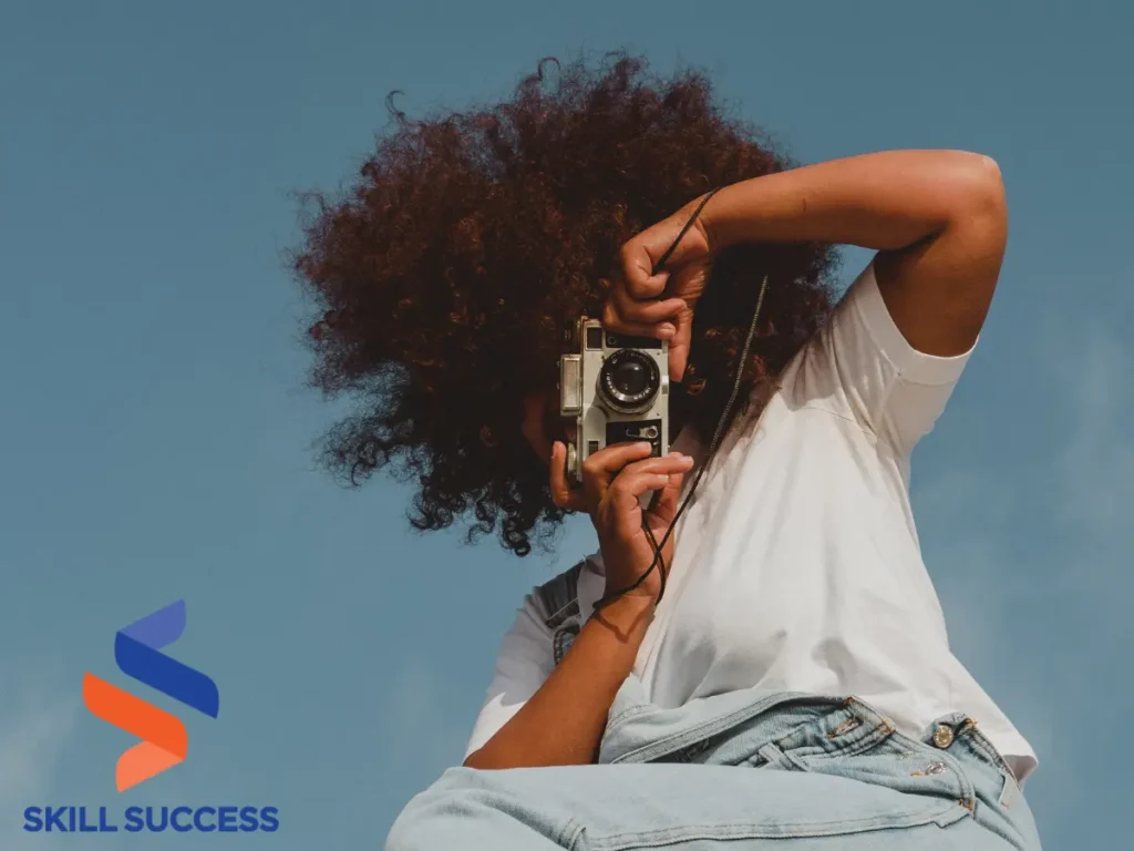 A woman capturing a moment with a camera - promoting continued learning after college