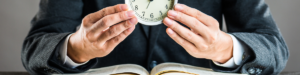 reader holding alarm clock