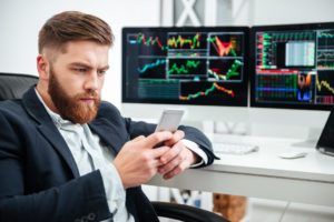 featured image serious businessman sitting stock market analysis