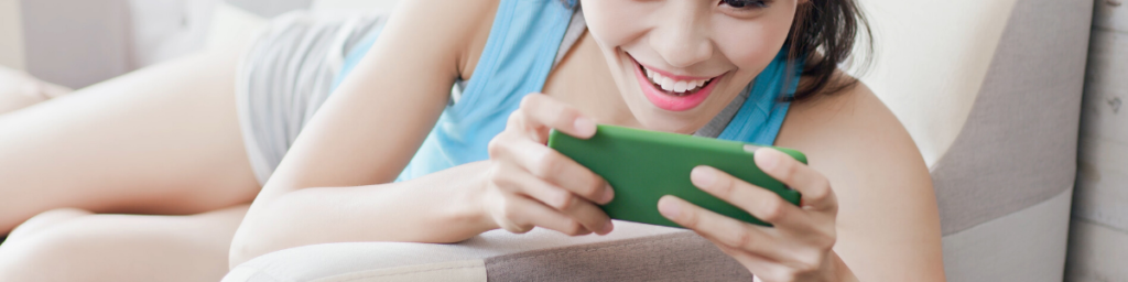 woman playing mobile games on the couch