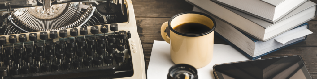 mug of coffee beside typewriter
