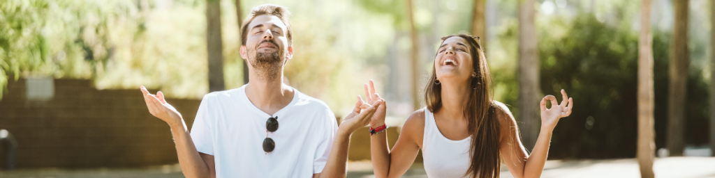 happy couple meditating to improve mood