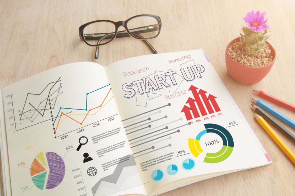 business-book-with-write-notebook-word-start-up-concept