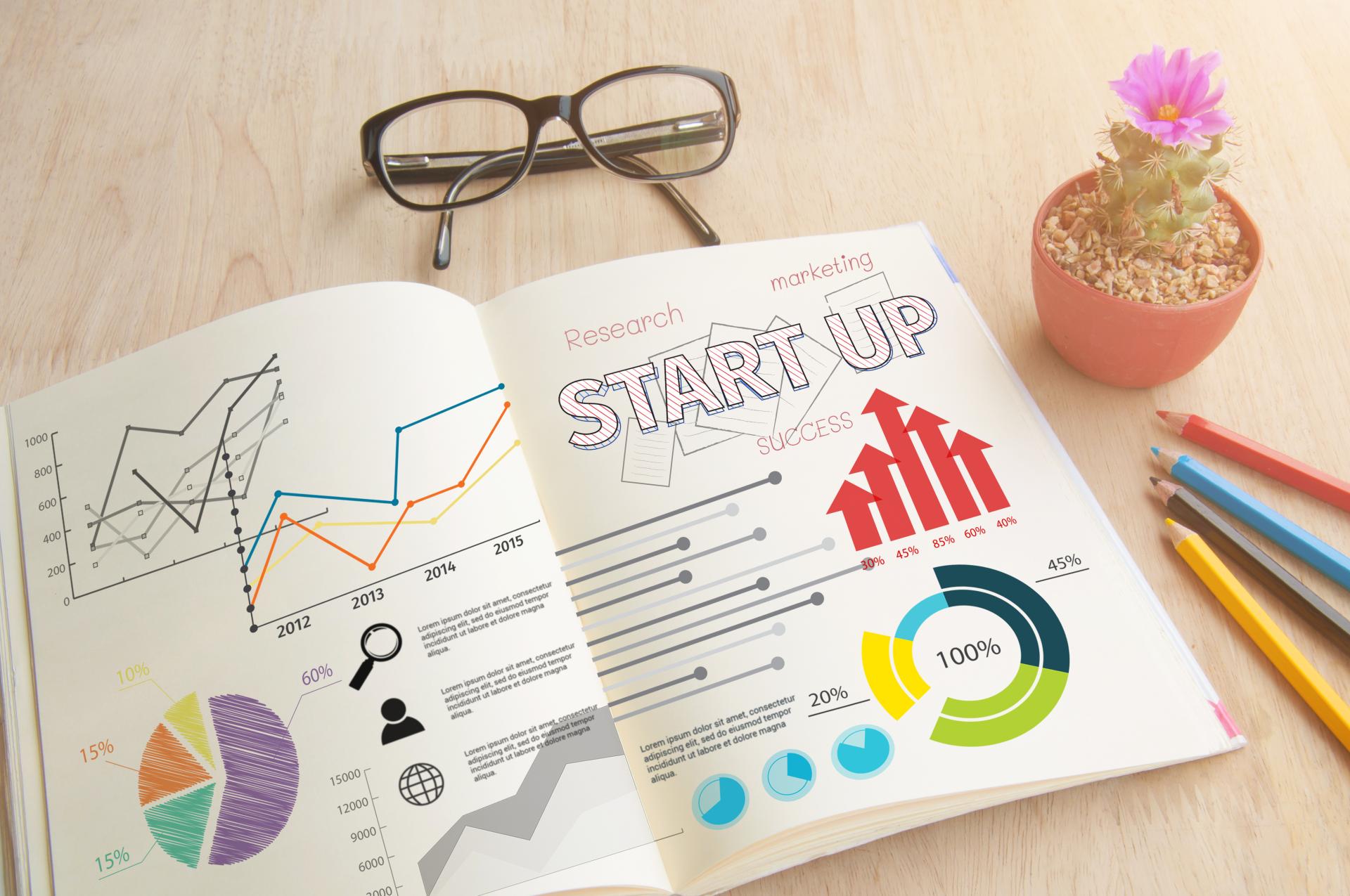 business-book-with-write-notebook-word-start-up-concept