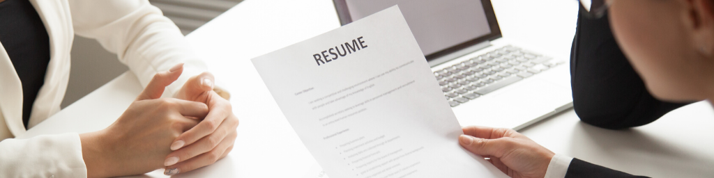 company-representatives-reading-applicant-resume-at-hiring