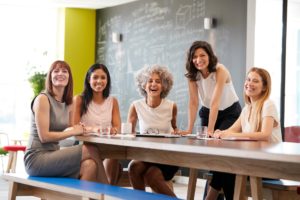 happy-female-colleagues-at-a-work-meeting-smiling-to-camera