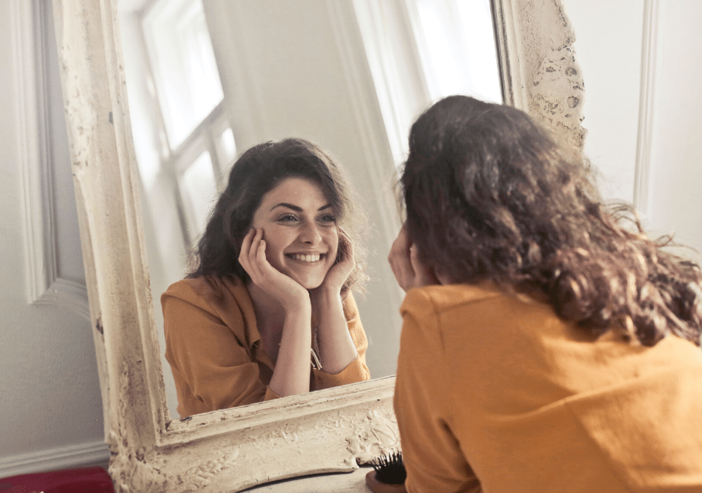 happy-woman-looking-at-the-mirror