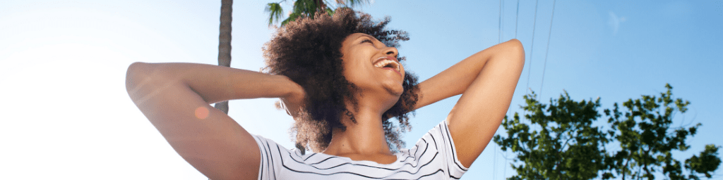 happy-woman-smiling-with-hands-behind-head