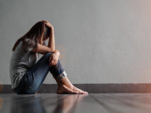 sad-woman-hug-her-knee-and-cry-while-sitting-alone-in-a-empty-room