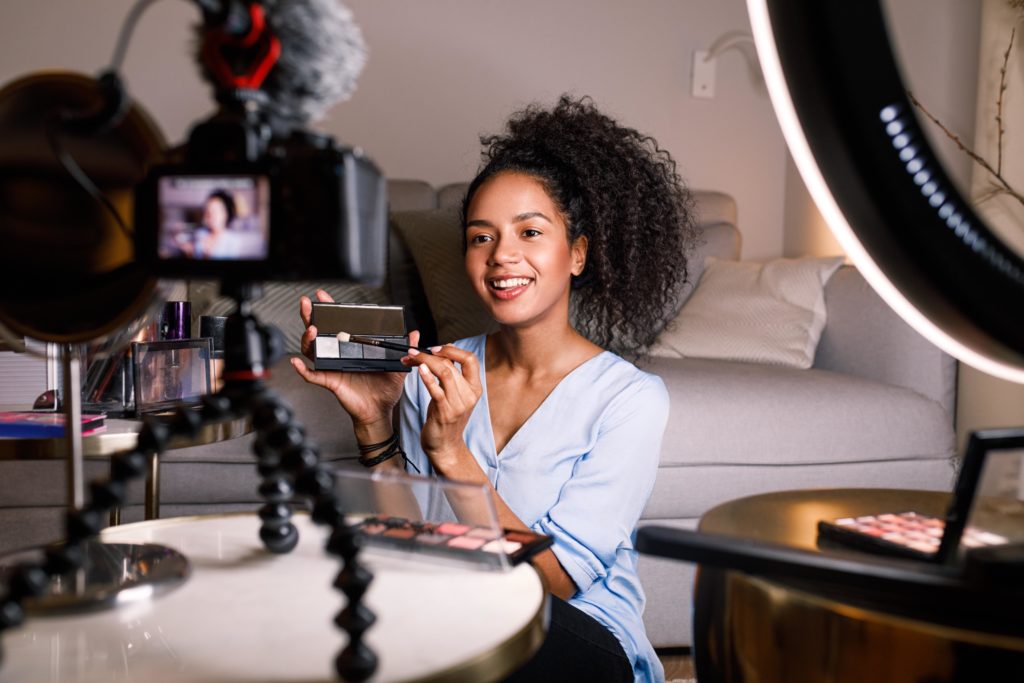 smiling-woman-recording-a-video-for-blog