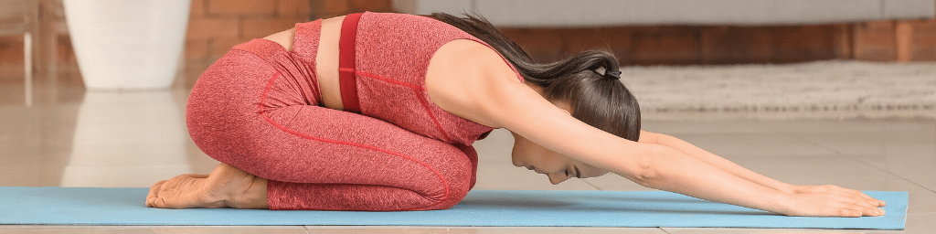 sporty-young-woman-practicing-yoga-at-home