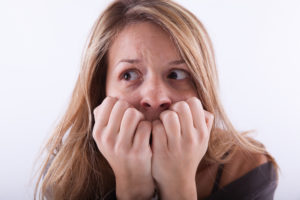 anxious-and-afraid-woman-on-white-background