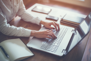 female-working-with-laptop-at-home-woman-s-hands-on