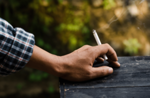 man-holding-a-lit-cigarette