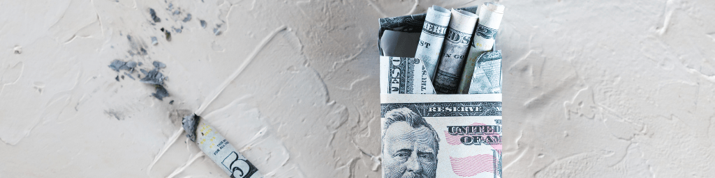 package-of-cigarette-filled-with-paper-money-dollars-banknote-and-cigarette-butt