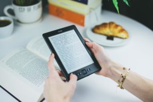 person-holding-kindle-e-book-reader