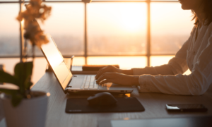 side-view-photo-of-a-female-programmer-using-laptop-working-typing-surfing-the-internet-at-workplace