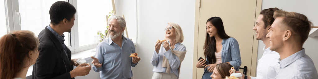 friendly-diverse-business-team-talking-and-laughing-eating-pizza-together