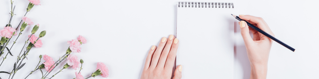 hand-writing-in-notebook-with-flowers