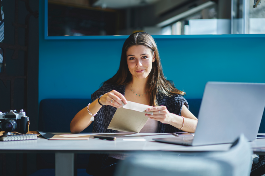 cheerful-business-woman-opening-a-business-letter