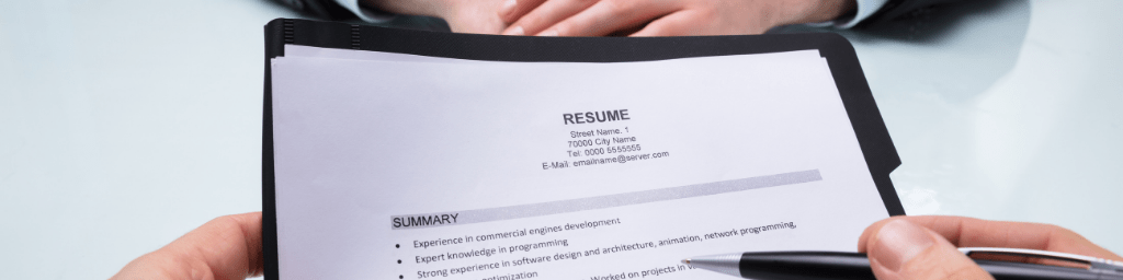 businessperson-s-hand-holding-resume