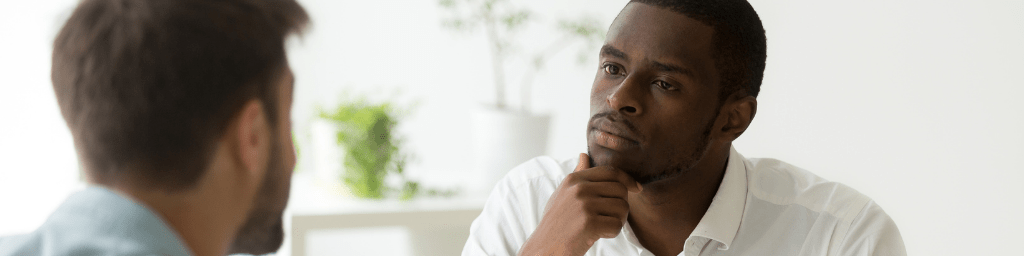 serious-attentive-african-hr-listening-to-candidate-at-job-interview