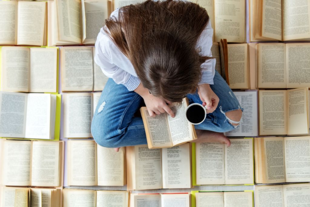 top-view-of-a-woman-reading-lots-of-books