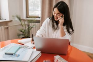 woman working remotely talking on phone