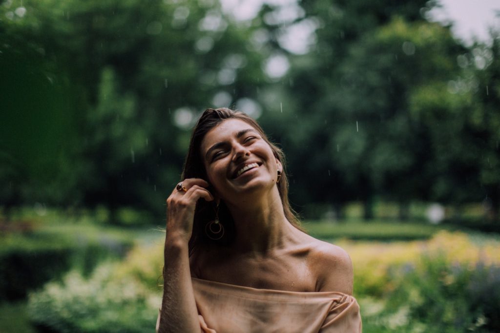 happy woman in off shoulder shirt smiling