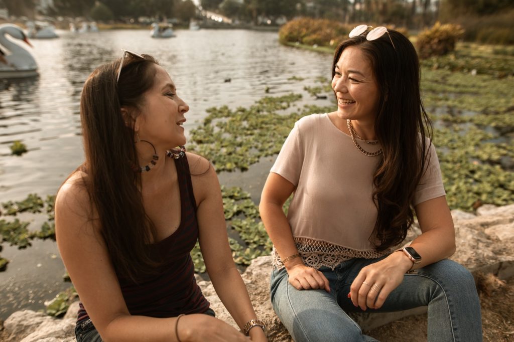 two women talking and smiling