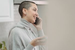 woman talking on smartphone in kitchen