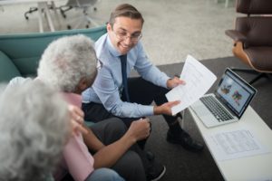 accountant showing documents to an elderly man