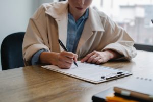 job applicant writing on clipboard during second interview