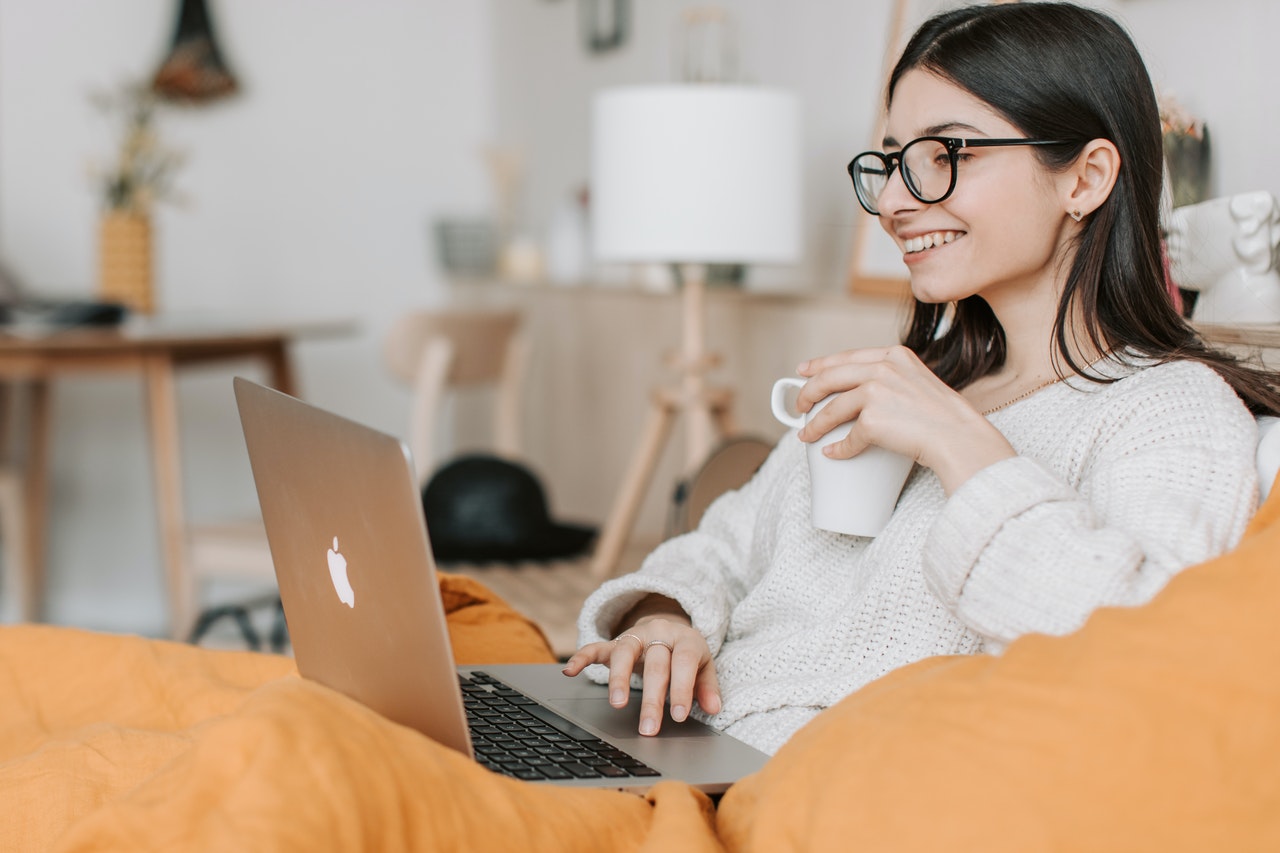 realtor having coffee while using laptop