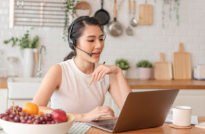 Asian businesswoman using computer laptop talking for video call conference meeting work from home