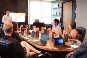 man presenting slide to team