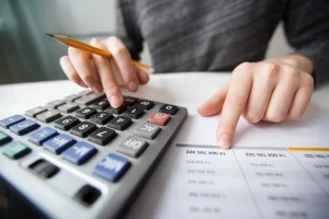 Closeup of accountant hands counting on calculator