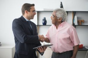 insurance agent shaking hands with client