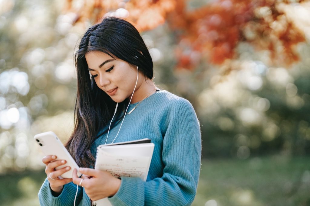 female student using app on iphone