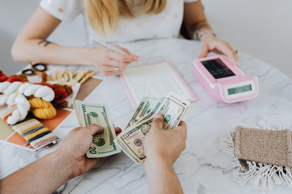 young adults counting dollar bills