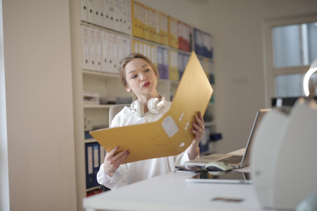 how to become an accountant looking at folder