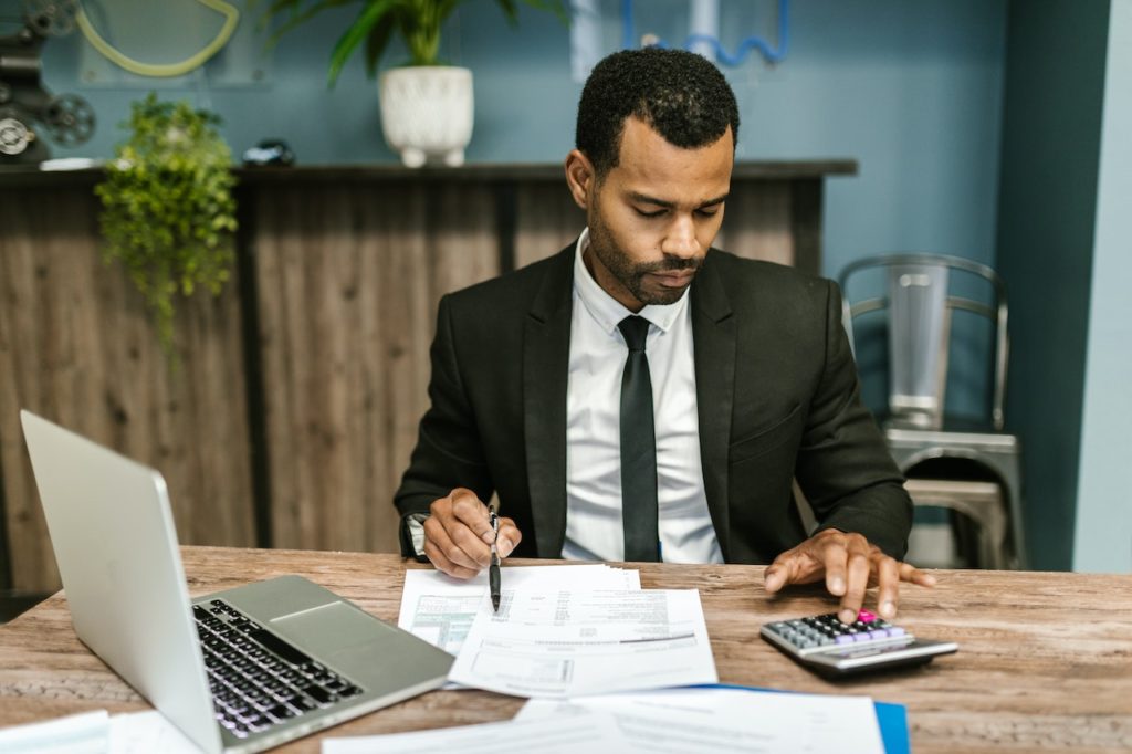 how to become an accountant wearing suit using calculator working