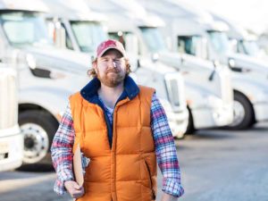 Fleet Manager Holding Clipboard Trucks