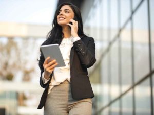 How Long Should You Stay At A Job Woman Talking Phone Holding Tablet