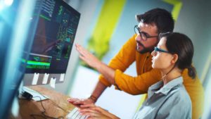 Software Developer Job Colleagues Looking at Code on Monitor