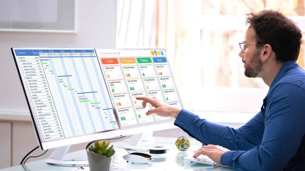 Work schedule man pointing at digital calendar