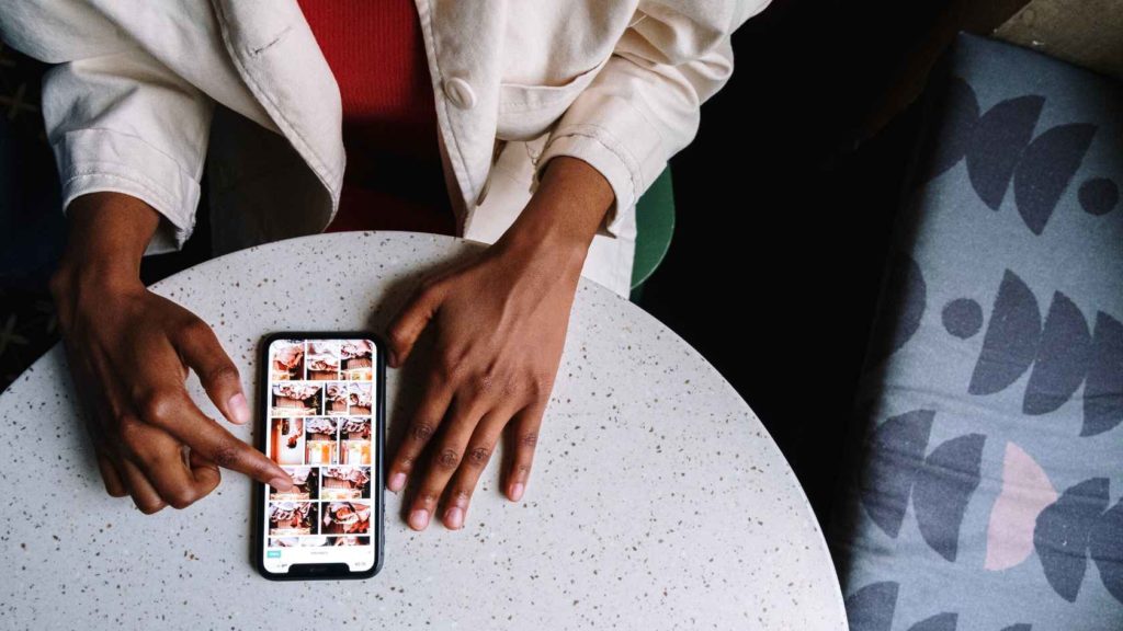 instagram feed mobile on table woman using app