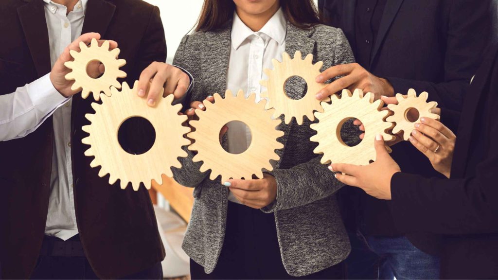 team alignment members holding gears