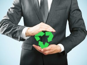 close up of business man's hand holding eco friendly symbol