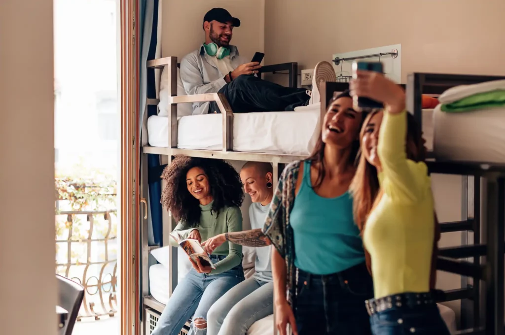 Students Hanging Out In College Housing Dorm Room